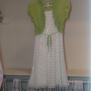 Ruffled white dress with green vest and sequins